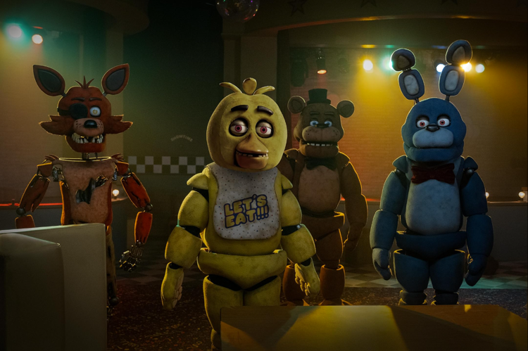 An official teaser image inside the Pizzeria of the animatronics, from left to right: Foxy, Chica, Freddy Fazbear, and Bonnie. Image source from Patti Perret/Universal Pictures.