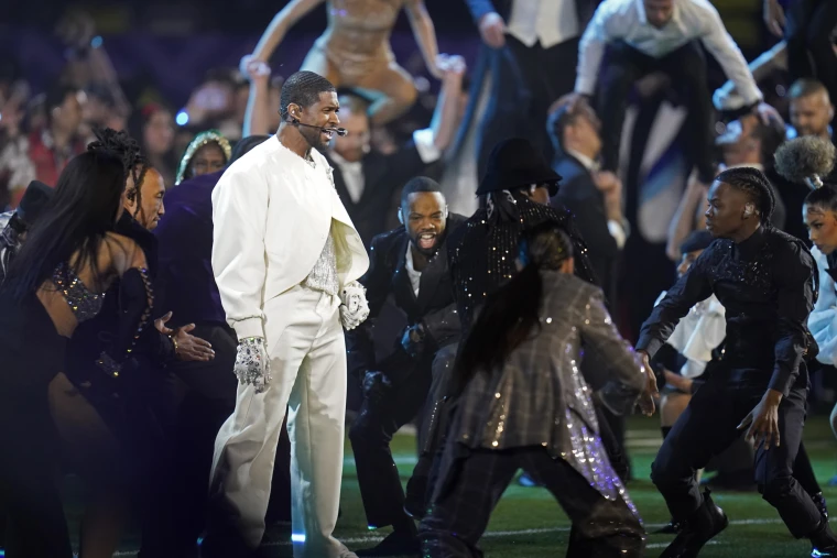 Usher’s performance began on the field, surrounded by dancers and contortionists 
photo, Steve Luciano / AP