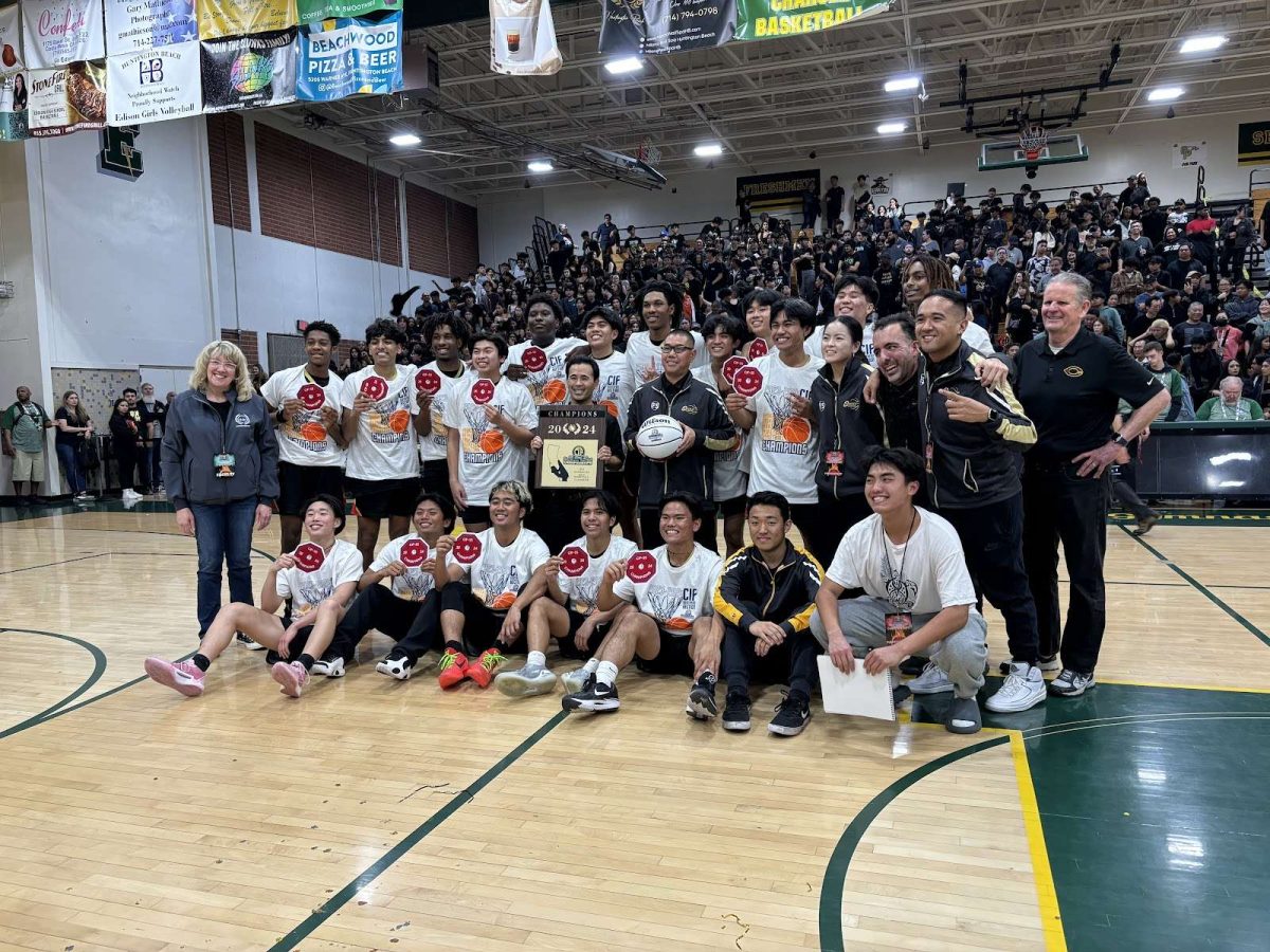 Boys Varsity Basketball and staff pose after winning the CIF Championship game