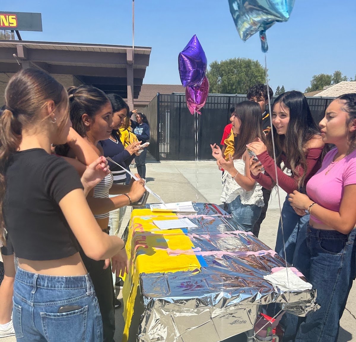 In photo: fashion club officers explain their club to potential members