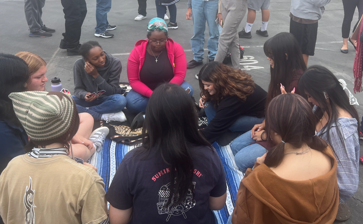 Members of Teacher Track play Uno to pass the time during the California Great ShakeOut.