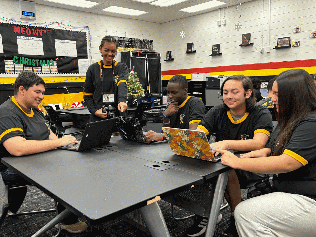 The yearbook staff working as a team on their spreads and pictures.