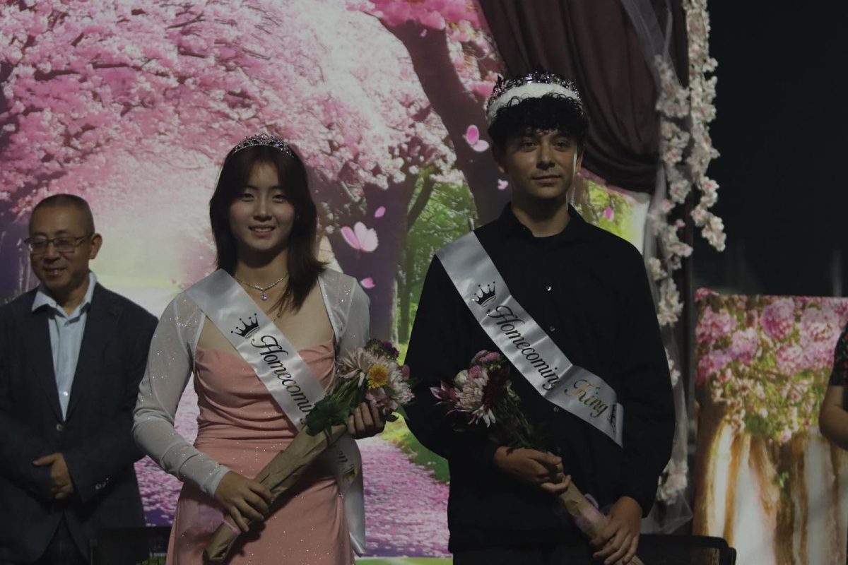 Homecoming King Alec Alvarez and Queen Amy Ge get crowned on stage