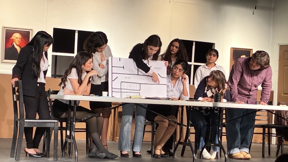 The jurors huddle together to reimagine the crime scene. Photo taken by Kamilla Barillas.