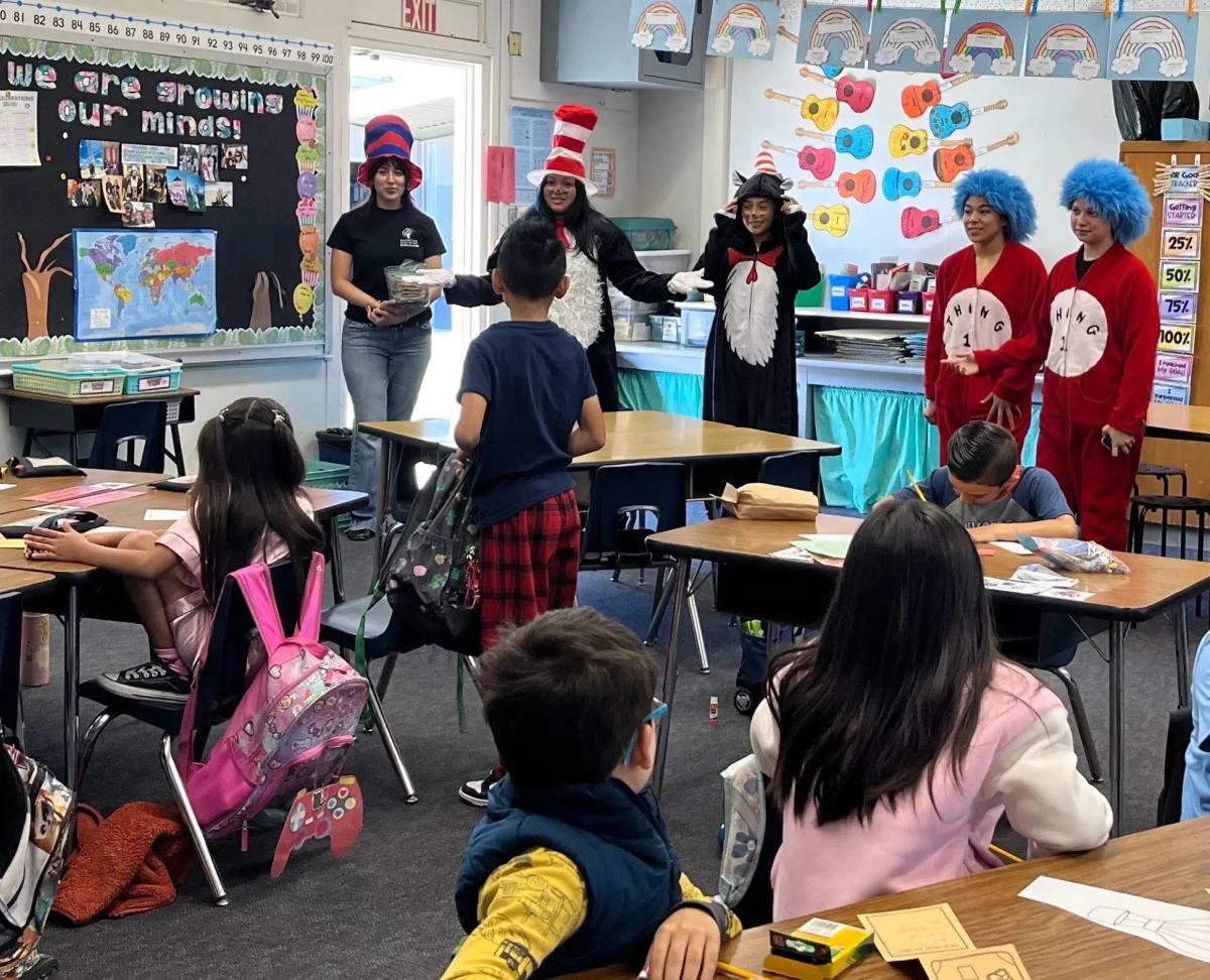 Teacher Track students visit a local elementary school dressed up as the Cat in the Hat, Thing 1, and Thing 2. Photo taken by teacher Ms. Laura Rheaume, used with permission.