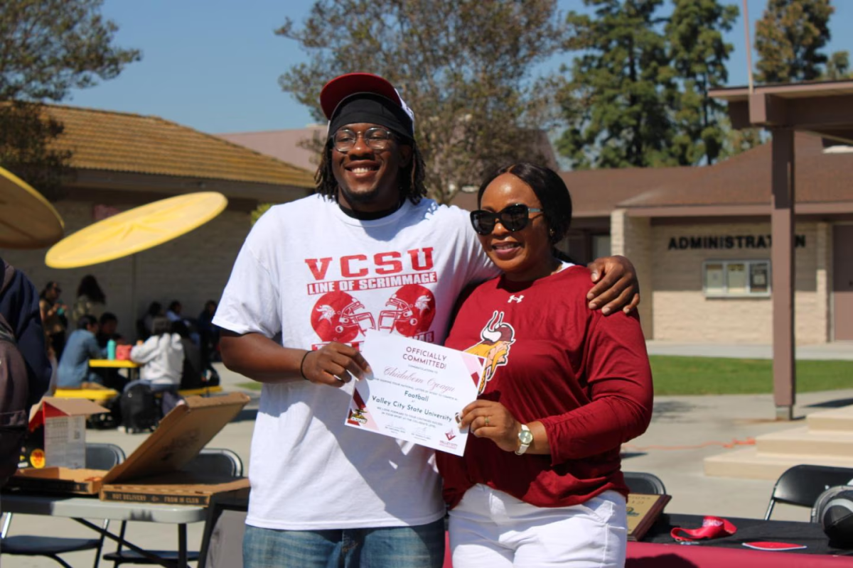 Senior Chidubem Ozoagu stands with his mother, holding his Certificate of Recognition proudly. Photo taken by Juliana Teh, used with permission.