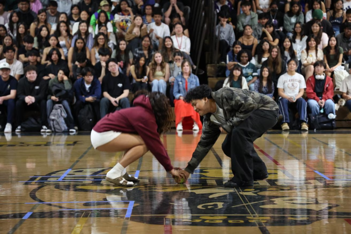 Students reach for the softball before the other in fierce competition. Photo taken by Janold Blanshard, used with permission.