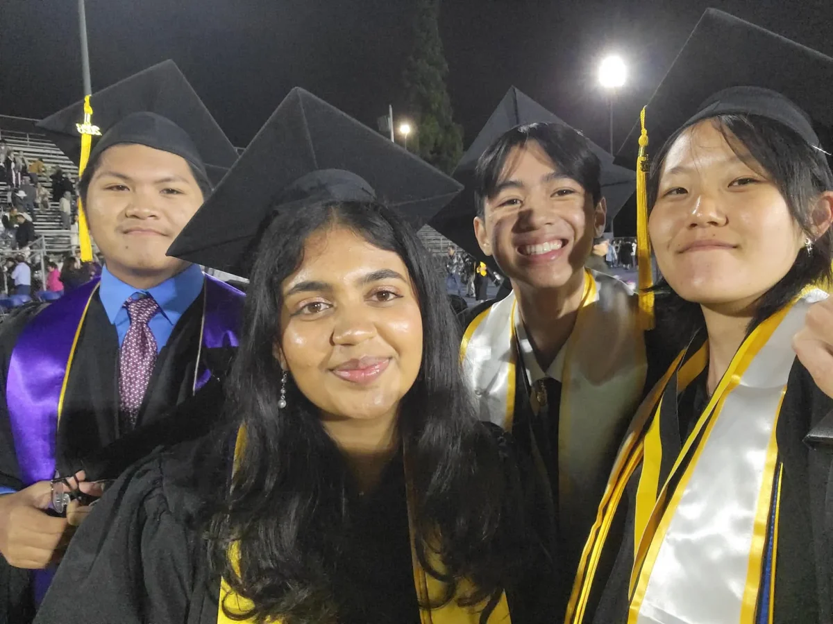 Seniors Zion Borriboonratana, Ian Santos, Riya Shah, and Han Song gather together after the ceremony. Fireworks are blasting in the background. Photo taken by Han Song.