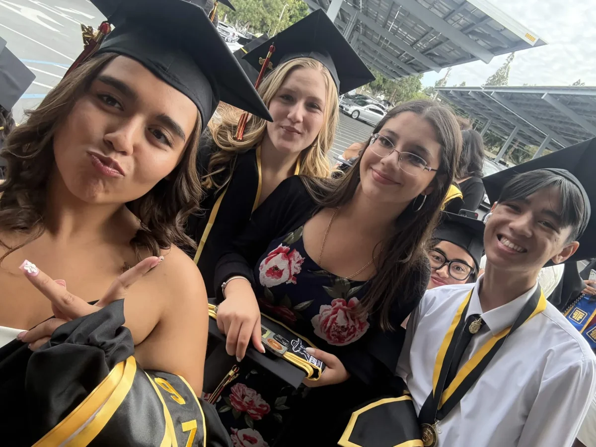 Seniors Zion Borriboonratana, Jazlyn Lopez, Skye Malabicky, and Emma Venegas wait in Gahr High School's parking lot together, excited for the graduation to come. Photo taken by Emma Venegas.