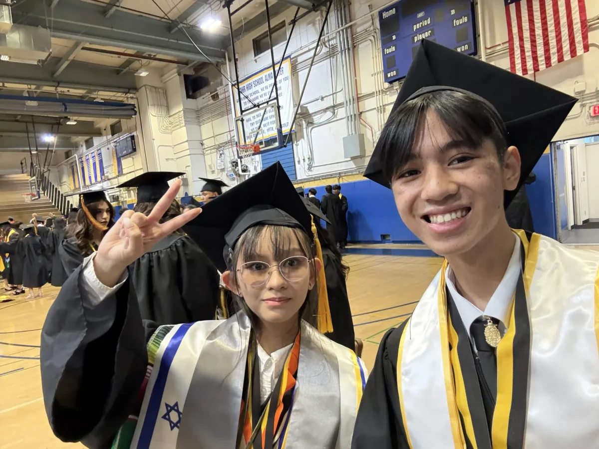 Seniors Zion Borriboonratana and Victoria Cienfuegos take a selfie in Gahr High School's West Gym as they prepare for the ceremony. Photo taken by Victoria Cienfuegos.